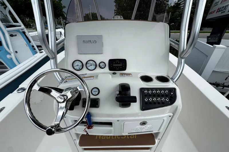 Slide: The Image of 2019 NauticStar 22 XS Offshore boat console with steering wheel and controls. - 10