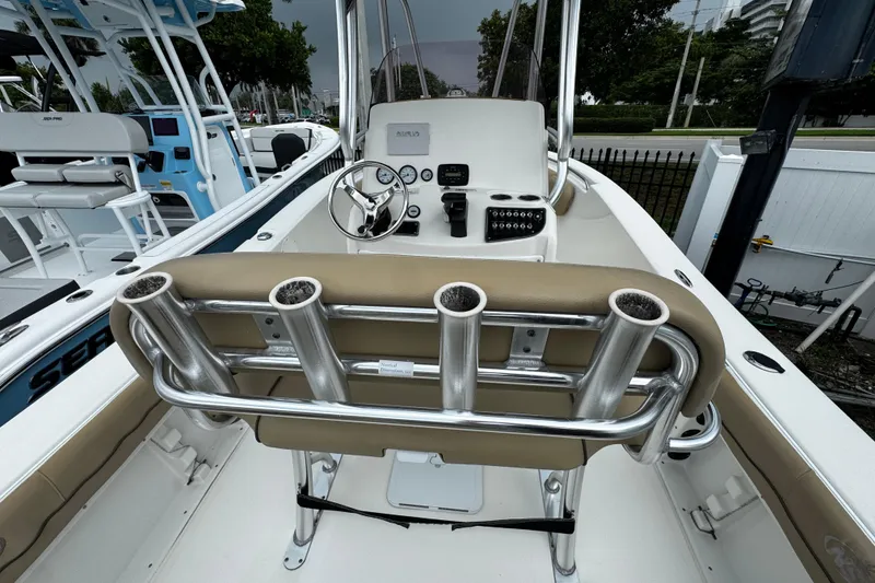 Slide: The Image of 2019 NauticStar 22 XS Offshore boat interior with steering console and rod holders. - 11