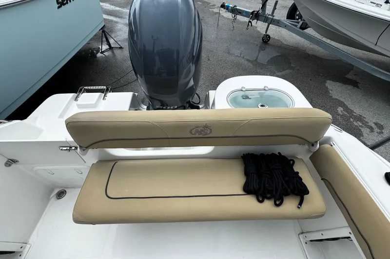 Slide: The Image of 2019 NauticStar 22 XS Offshore boat with seating and engine view. - 14
