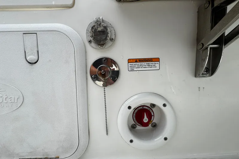 Slide: The Image of 2019 NauticStar 22 XS Offshore boat fuel and warning labels on the hull. - 16