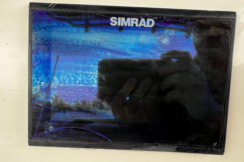 Slide: The Image of Simrad display on 2019 NauticStar 22 XS Offshore boat, showing reflections and watermarks. - 23