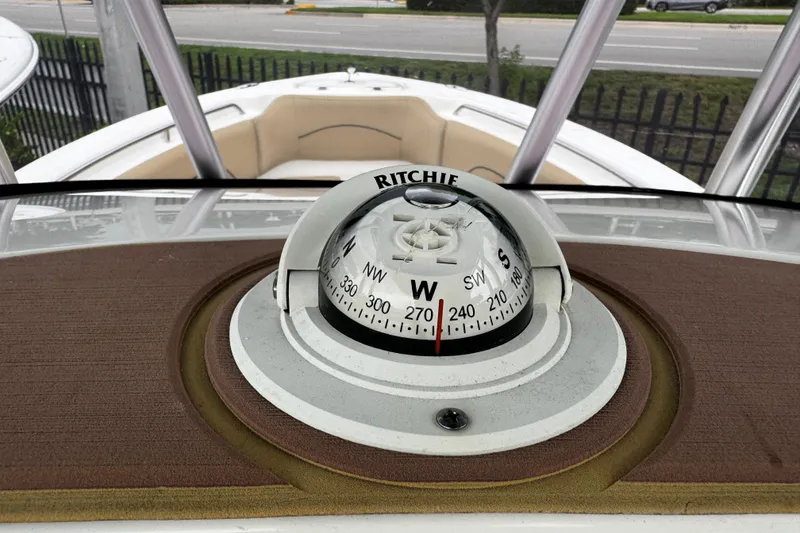 Slide: The Image of Compass on 2019 NauticStar 22 XS Offshore boat dashboard, showing west direction. - 25