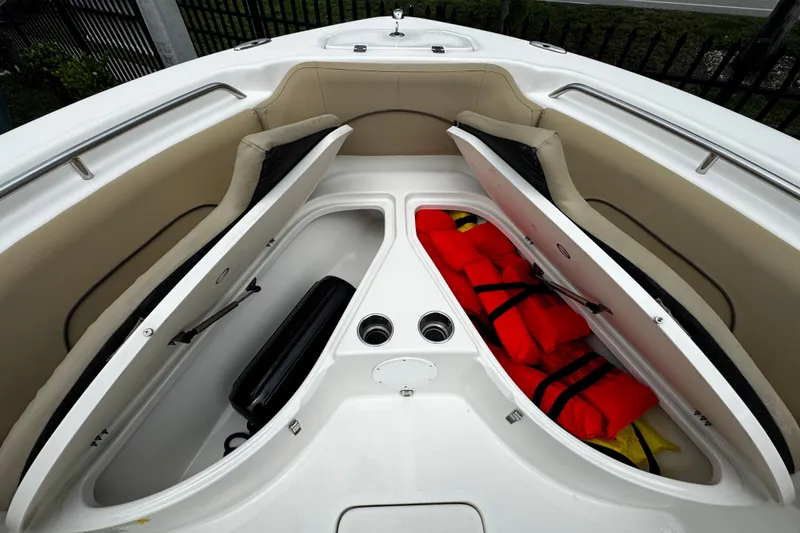 Slide: The Image of 2019 NauticStar 22 XS Offshore boat storage compartments with life jackets and equipment. - 6