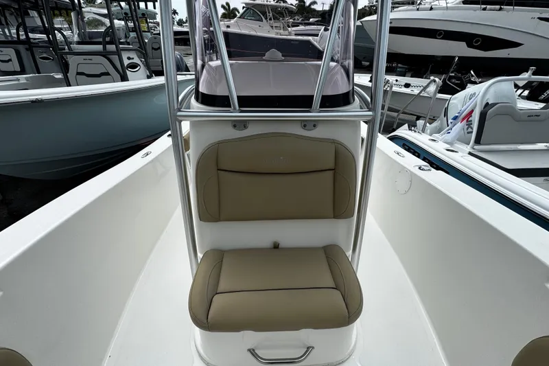 Slide: The Image of 2019 NauticStar 22 XS Offshore boat interior with tan seating and console. - 9