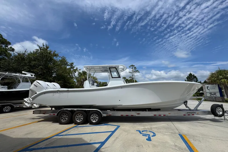 Slide: The Image of 2026 Yellowfin 36 Offshore boat on trailer under clear sky. - 10