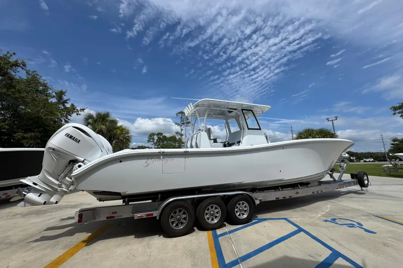Slide: The Image of 2026 Yellowfin 36 Offshore boat on trailer under blue sky. - 11