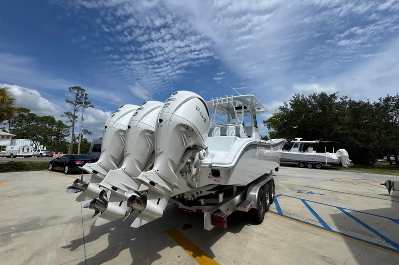 Slide: The Image of 2026 Yellowfin 36 Offshore boat with triple outboard engines on a trailer. - 13