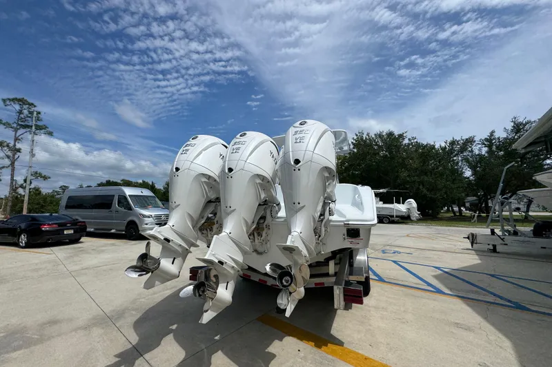 Slide: The Image of 2026 Yellowfin 36 Offshore boat with triple outboard engines on a trailer. - 14