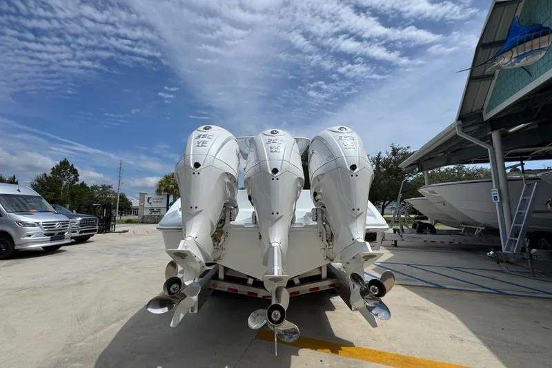 Slide: The Image of 2026 Yellowfin 36 Offshore boat with triple outboard engines in a marina setting. - 15