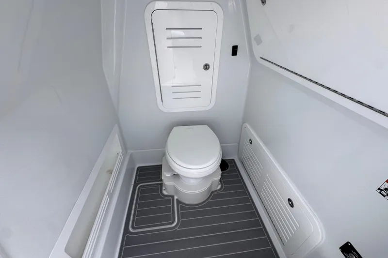 Slide: The Image of 2026 Yellowfin 36 Offshore boat bathroom interior with modern toilet and storage compartments. - 27