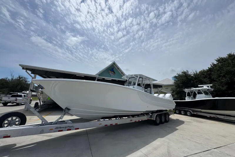 Slide: The Image of 2026 Yellowfin 36 Offshore boat on trailer under cloudy sky. - 3