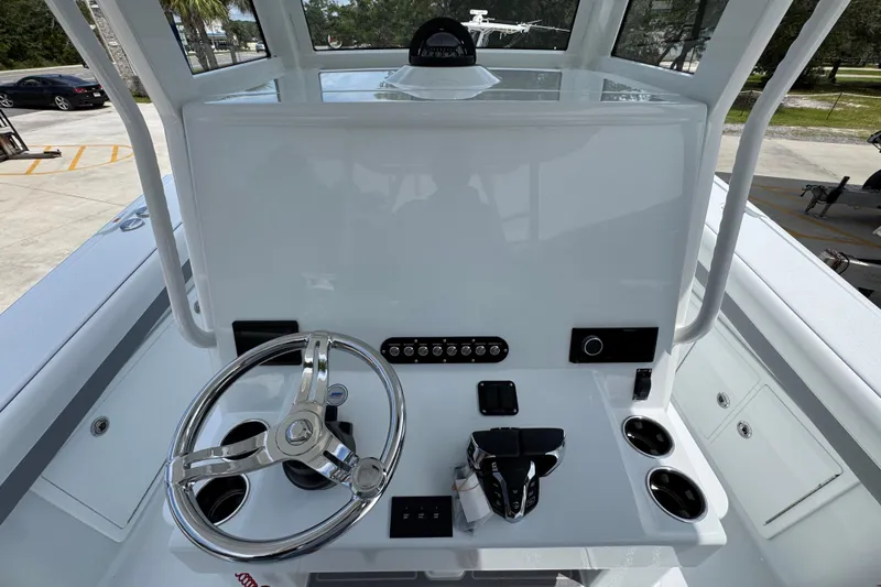 Slide: The Image of 2026 Yellowfin 36 Offshore boat helm with steering wheel and control panel. - 32