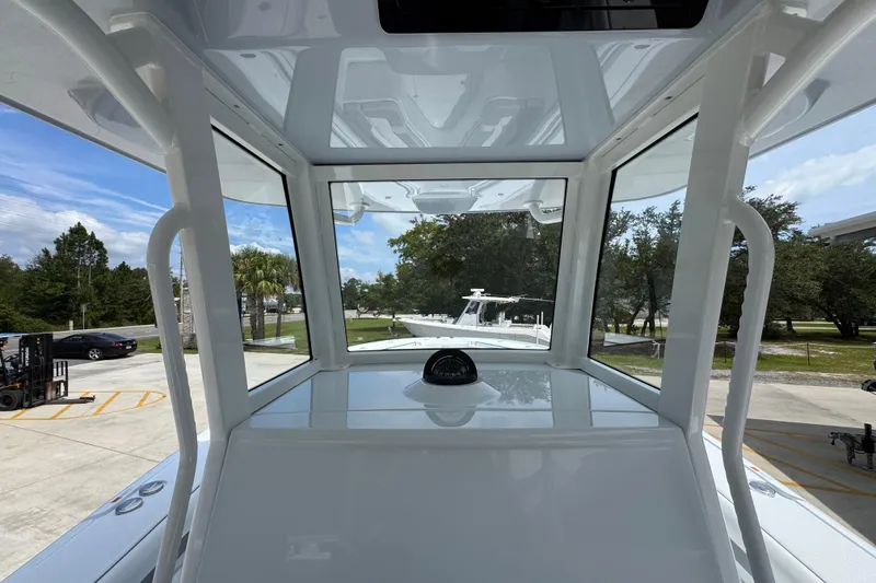 Slide: The Image of 2026 Yellowfin 36 Offshore boat interior view with clear windows and outdoor scenery. - 33