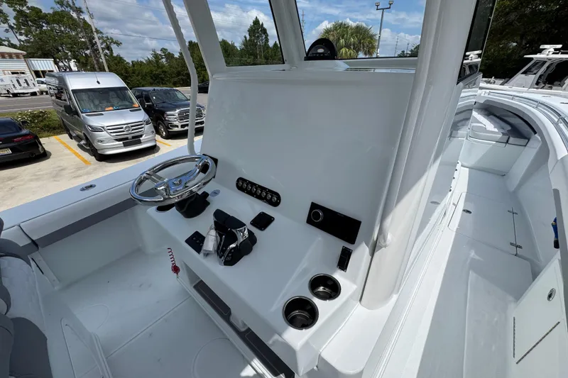 Slide: The Image of 2026 Yellowfin 36 Offshore boat cockpit with steering wheel and control panel. - 34