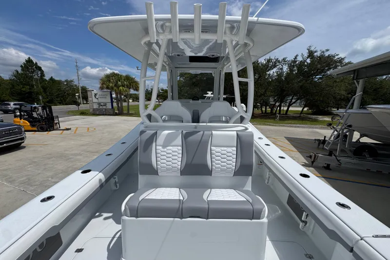 Slide: The Image of 2026 Yellowfin 36 Offshore boat with sleek seating and modern design in a marina setting. - 37