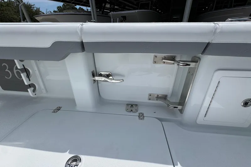 Slide: The Image of 2026 Yellowfin 36 Offshore boat interior, featuring sleek white and gray seating and stainless steel hardware. - 38