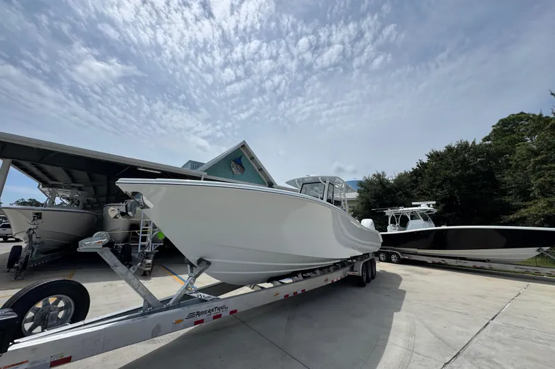 Slide: The Image of 2026 Yellowfin 36 Offshore boat on trailer under cloudy sky. - 4