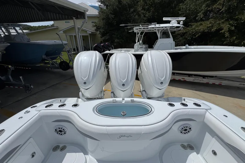 Slide: The Image of 2026 Yellowfin 36 Offshore boat with triple outboard engines, docked in a marina. - 40