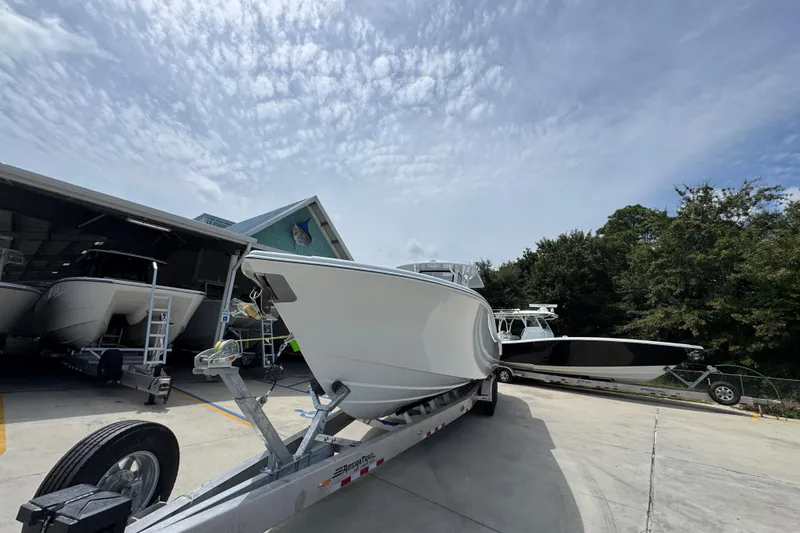 Slide: The Image of 2026 Yellowfin 36 Offshore boat on trailer under cloudy sky. - 5