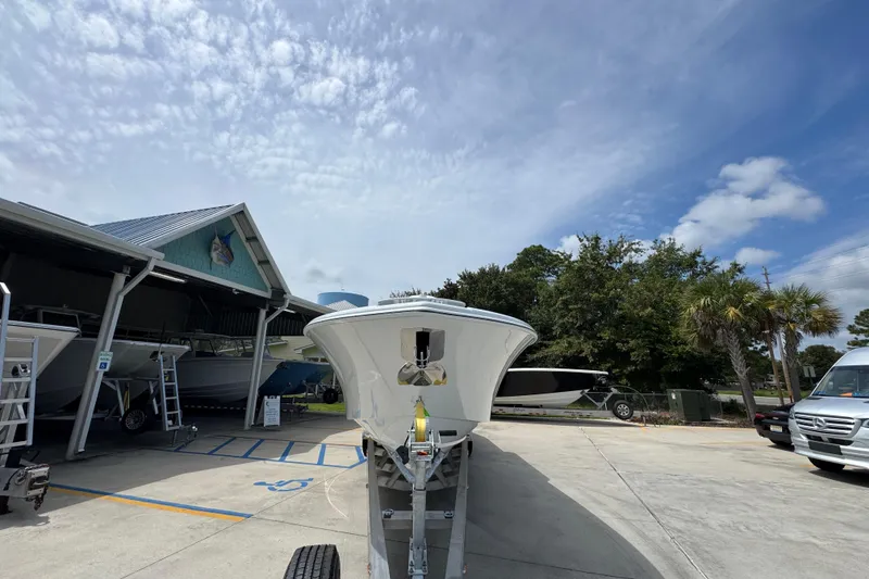 Slide: The Image of 2026 Yellowfin 36 Offshore boat on trailer at marina under blue sky. - 6