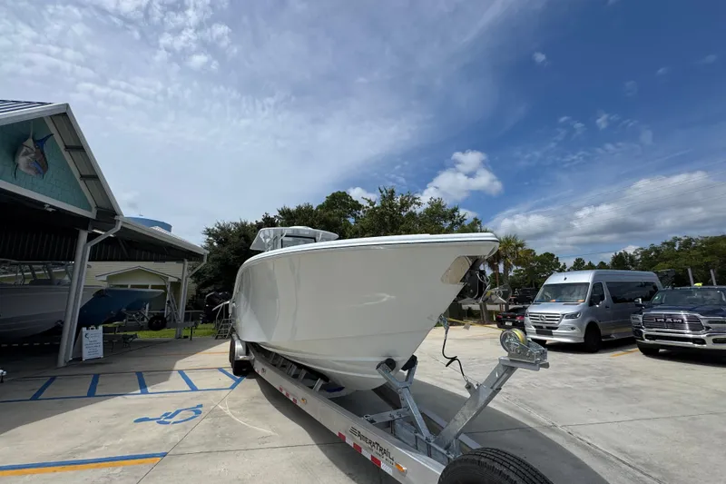 Slide: The Image of 2026 Yellowfin 36 Offshore boat on trailer under a partly cloudy sky. - 7