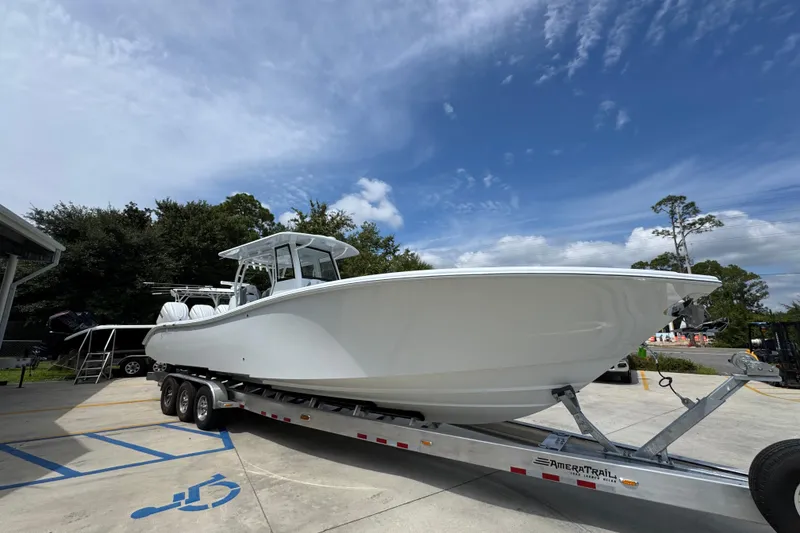 Slide: The Image of 2026 Yellowfin 36 Offshore boat on trailer under clear blue sky. - 8