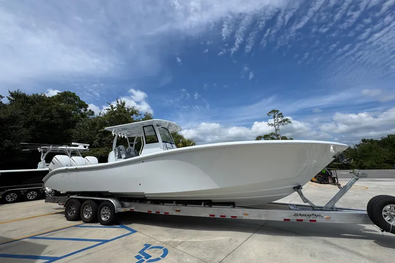 Slide: The Image of 2026 Yellowfin 36 Offshore boat on trailer under a clear blue sky. - 9
