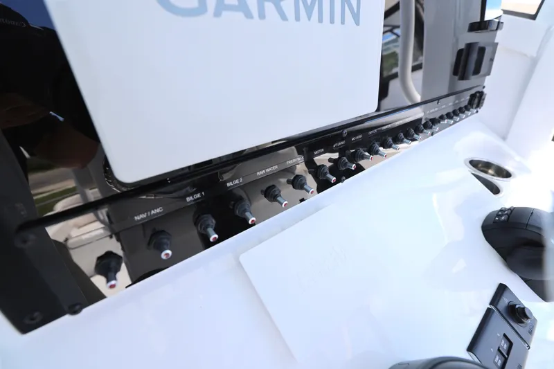 Slide: The Image of 2026 Sea Hunt Ultra 265 SE boat dashboard with Garmin navigation system. - 19