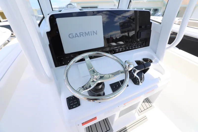Slide: The Image of 2026 Sea Hunt Ultra 265 SE dashboard with Garmin and Fusion audio controls. - 20