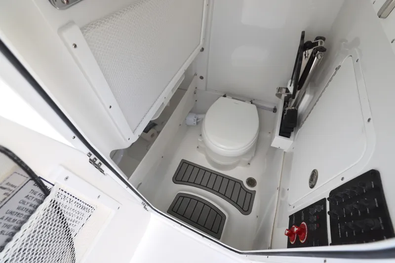 Slide: The Image of 2026 Sea Hunt Ultra 265 SE boat top with rod holders and speakers against blue sky. - 23