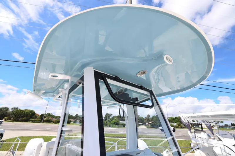 Slide: The Image of Interior of 2026 Sea Hunt Ultra 265 SE boat, featuring a compact marine toilet. - 25