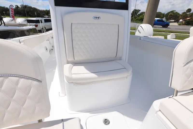 Slide: The Image of 2026 Sea Hunt Ultra 265 SE boat with sleek blue T-top under clear sky. - 27