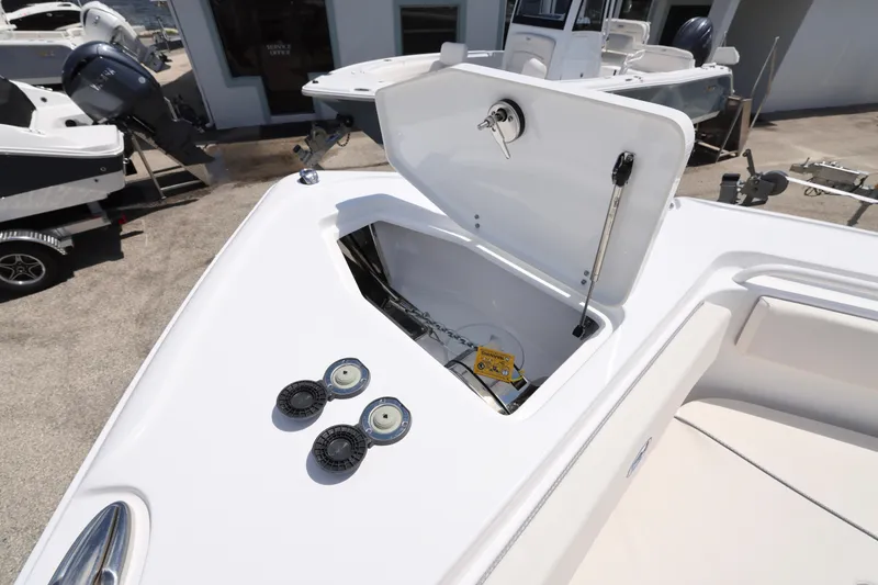 Slide: The Image of 2026 Sea Hunt Ultra 265 SE boat interior with cushioned seating and storage. - 28