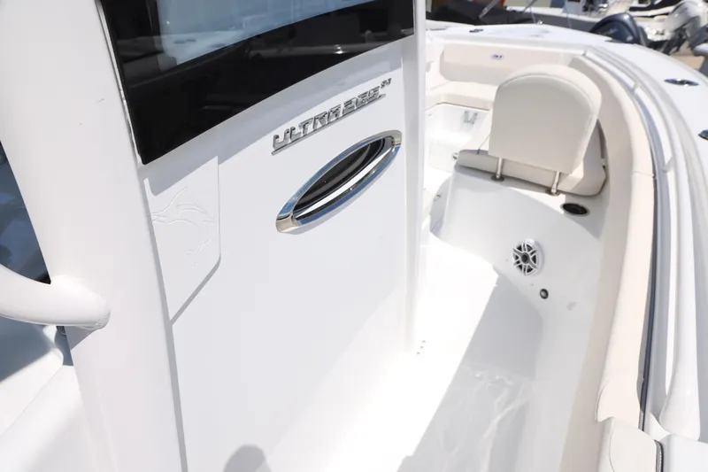 Slide: The Image of 2026 Sea Hunt Ultra 265 SE boat interior with white cushioned seating. - 31