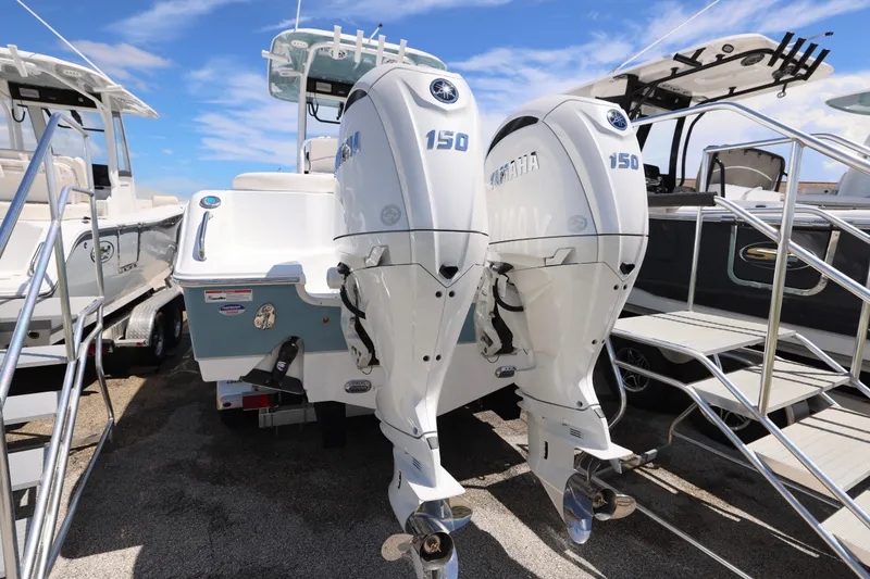 Slide: The Image of 2026 Sea Hunt Ultra 265 SE boat with dual Yamaha outboard engines, parked on a trailer. - 9