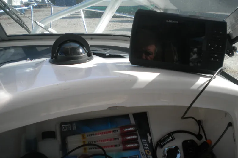 Slide: The Image of 1999 Pro-Line 24 Walkaround boat dashboard with Garmin GPS and compass. - 12