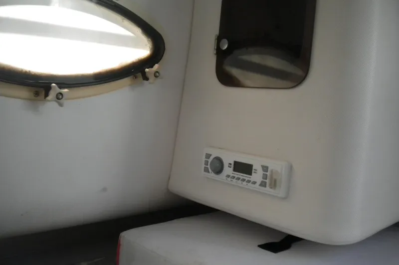 Slide: The Image of Interior of 1999 Pro-Line 24 Walkaround boat with window and control panel. - 17