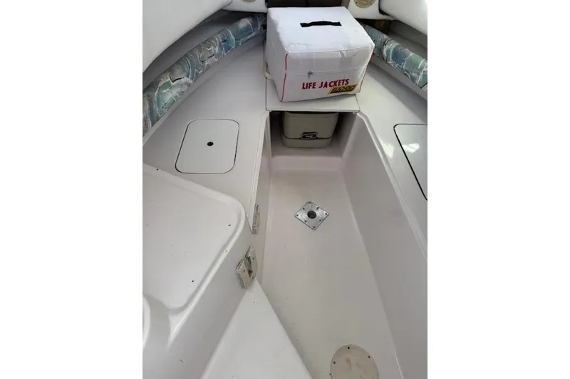 Slide: The Image of Interior of 1999 Pro-Line 24 Walkaround boat with life jackets stored. - 18