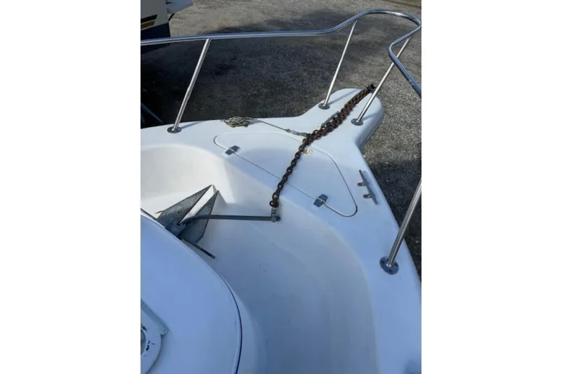 Slide: The Image of 1999 Pro-Line 24 Walkaround boat bow with anchor and chain. - 7