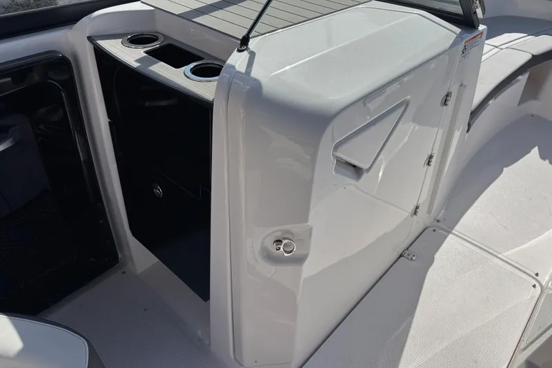 Slide: The Image of 2025 Yamaha Boats AR250 interior with cup holders and storage compartment. - 14