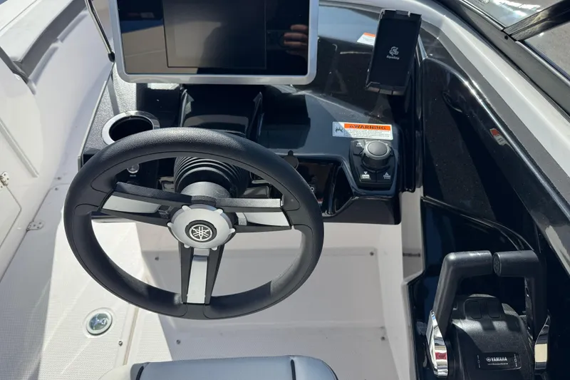 Slide: The Image of 2025 Yamaha AR250 boat dashboard with steering wheel and control panel. - 20