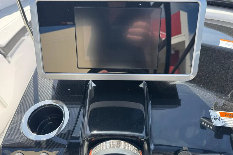 Slide: The Image of 2025 Yamaha AR250 boat dashboard with touchscreen display and cup holder. - 22