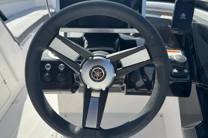 Slide: The Image of Steering wheel of 2025 Yamaha Boats AR250, featuring modern controls and sleek design. - 23