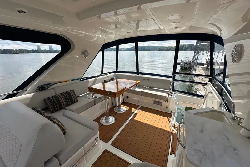 Slide: The Image of Luxurious 2017 Sea Ray Fly 460 yacht interior with elegant seating and scenic water views. - 17