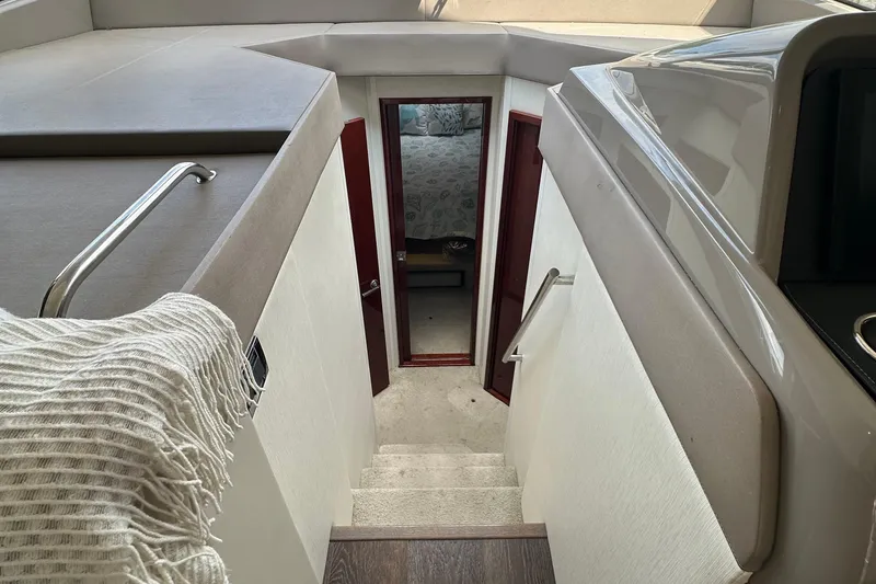 Slide: The Image of Interior view of 2017 Sea Ray Fly 460 yacht, featuring stairs leading to a cabin. - 7