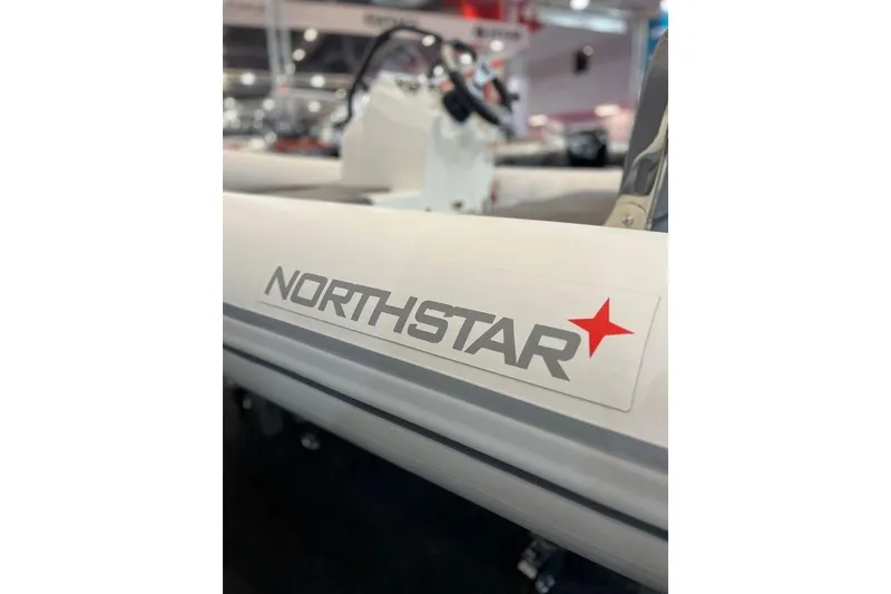 Slide: The Image of 2026 Northstar Vega 3.8 boat logo with red star emblem. - 2