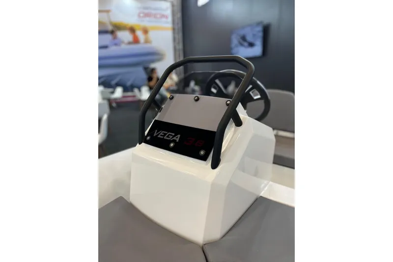 Slide: The Image of 2026 Northstar Vega 3.8 boat console with steering wheel, showcased indoors. - 3