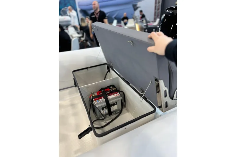Slide: The Image of Open storage compartment in 2026 Northstar Vega 3.8 boat, revealing battery inside. - 6