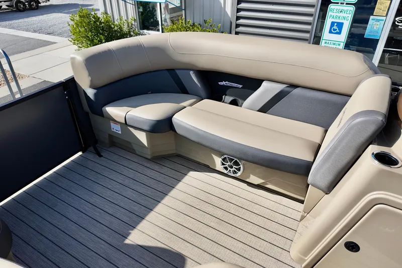 Slide: The Image of 2026 Sylvan Mirage X3 CLZ boat interior with beige seating and speaker system. - 10