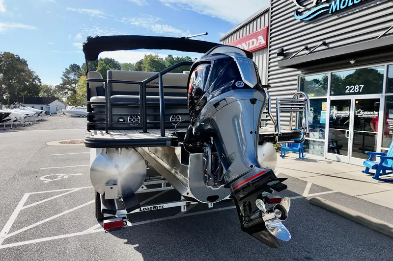 Slide: The Image of 2026 Sylvan Mirage X3 CLZ pontoon boat with powerful outboard motor at dealership. - 12